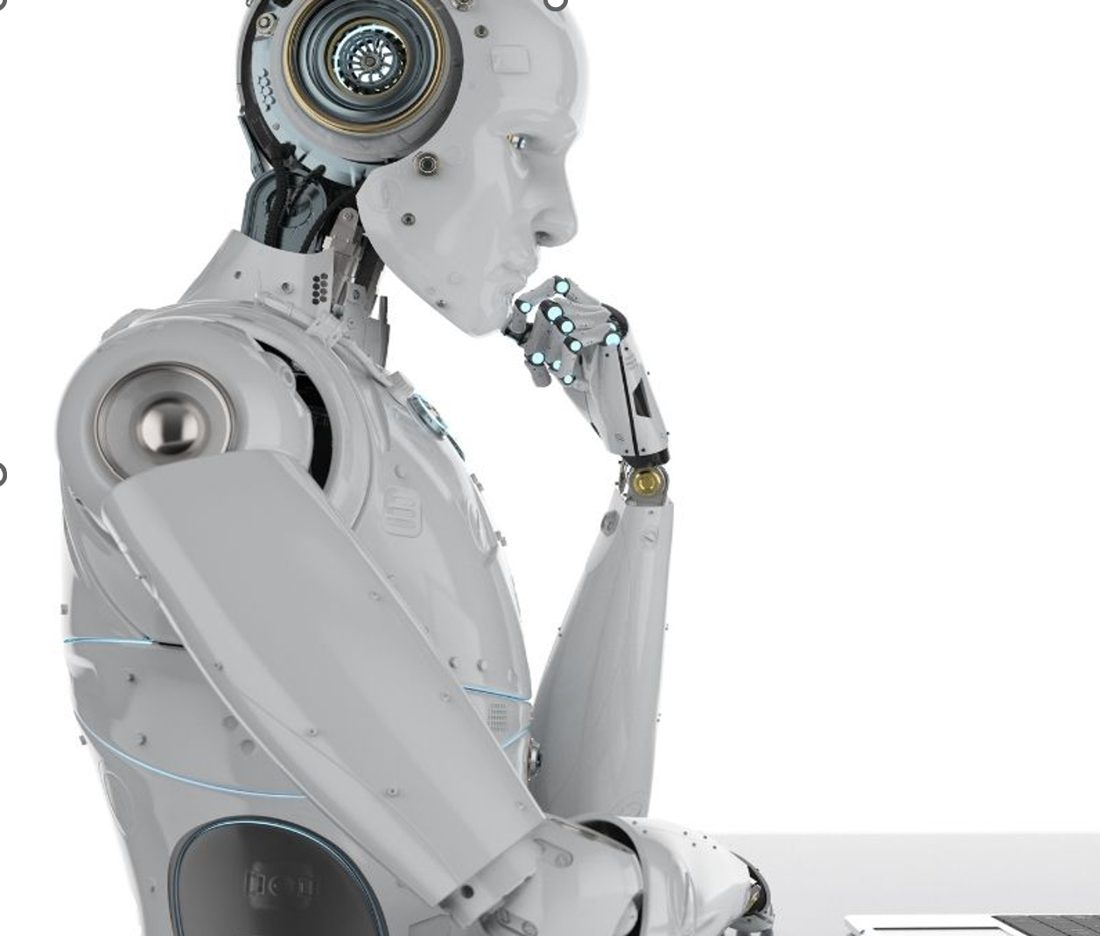 A humanoid robot in a thinking pose, considering a laptop